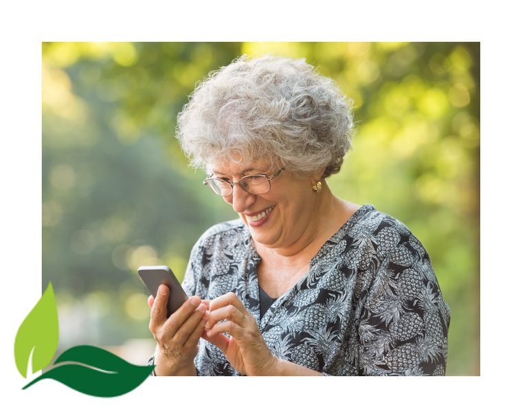 Senhora usando o celular na oficina de Tecnologia